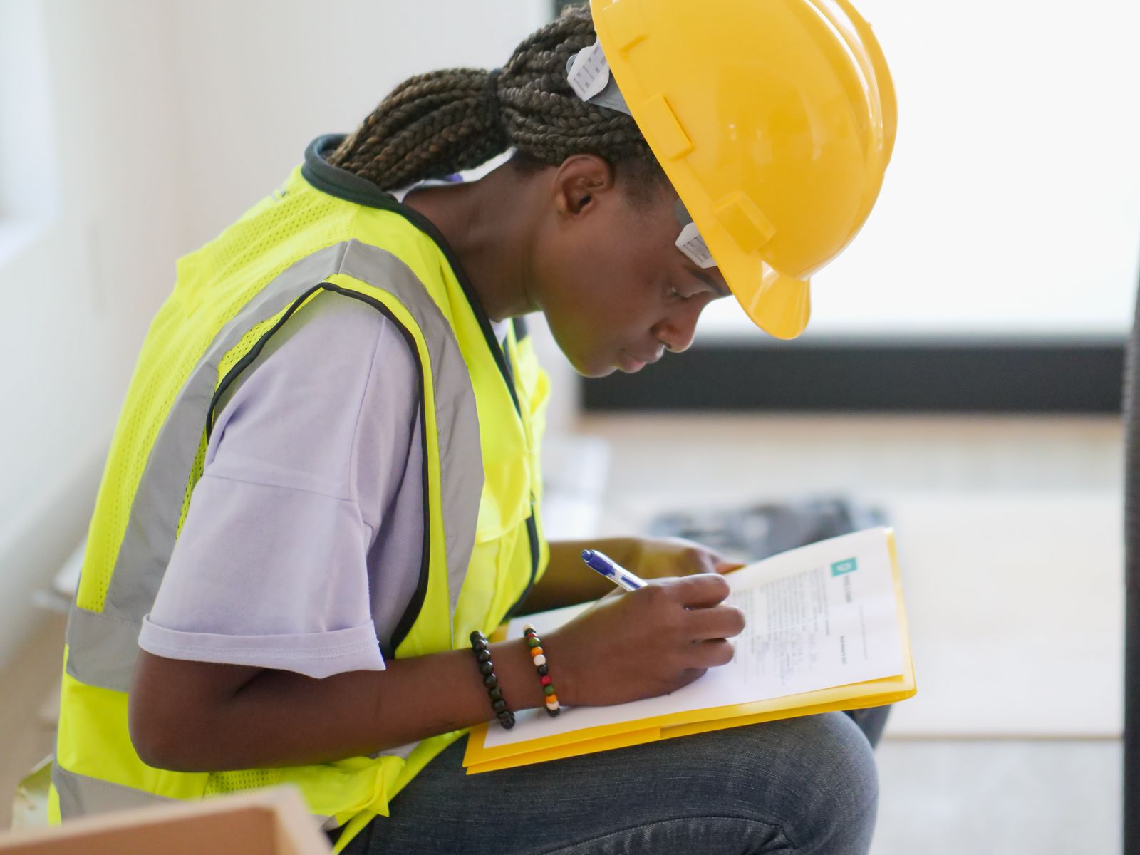 Safety professional completing an inspection checklist while wearing protective equipment